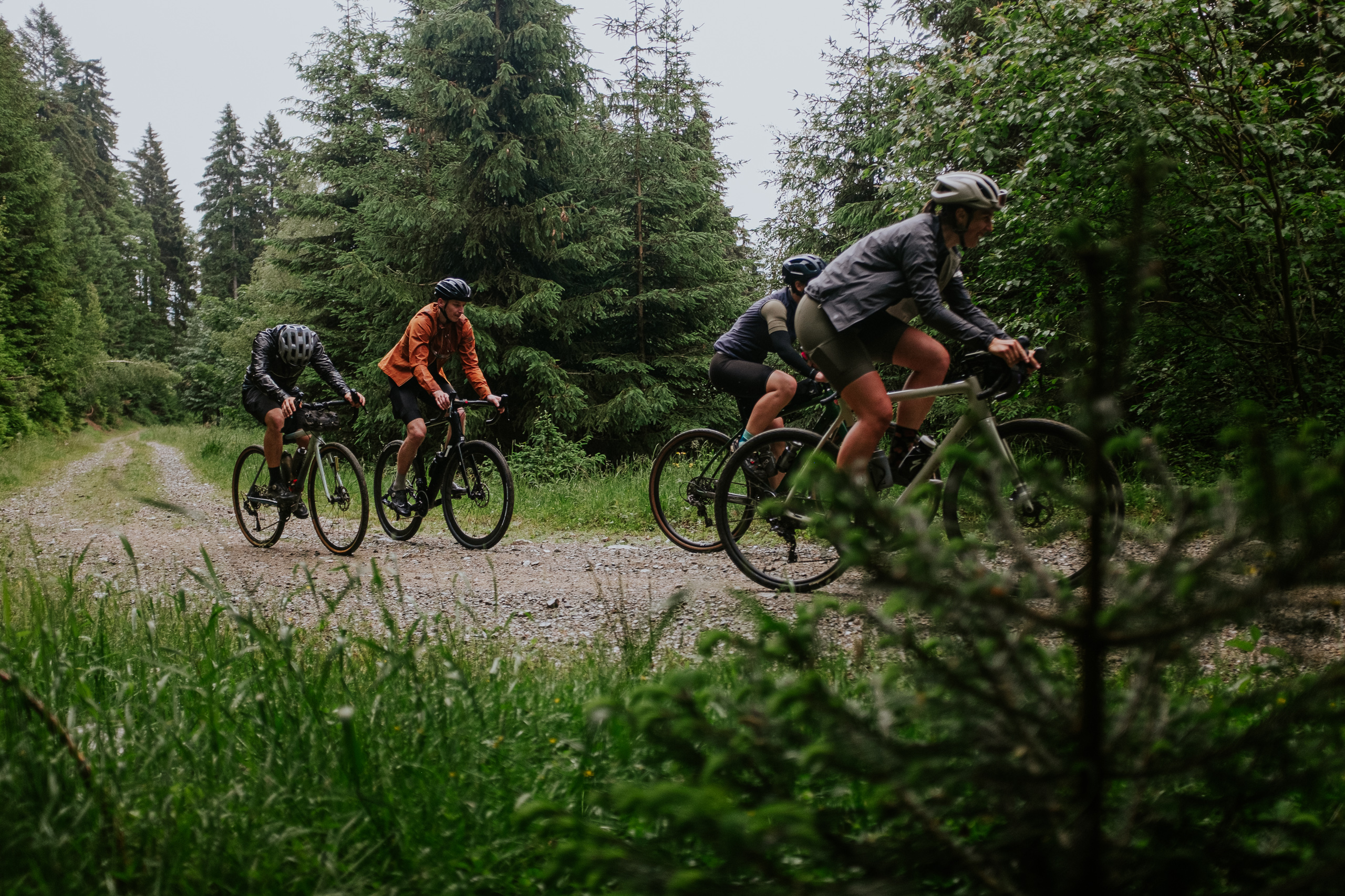 four riders in a rainy terrain